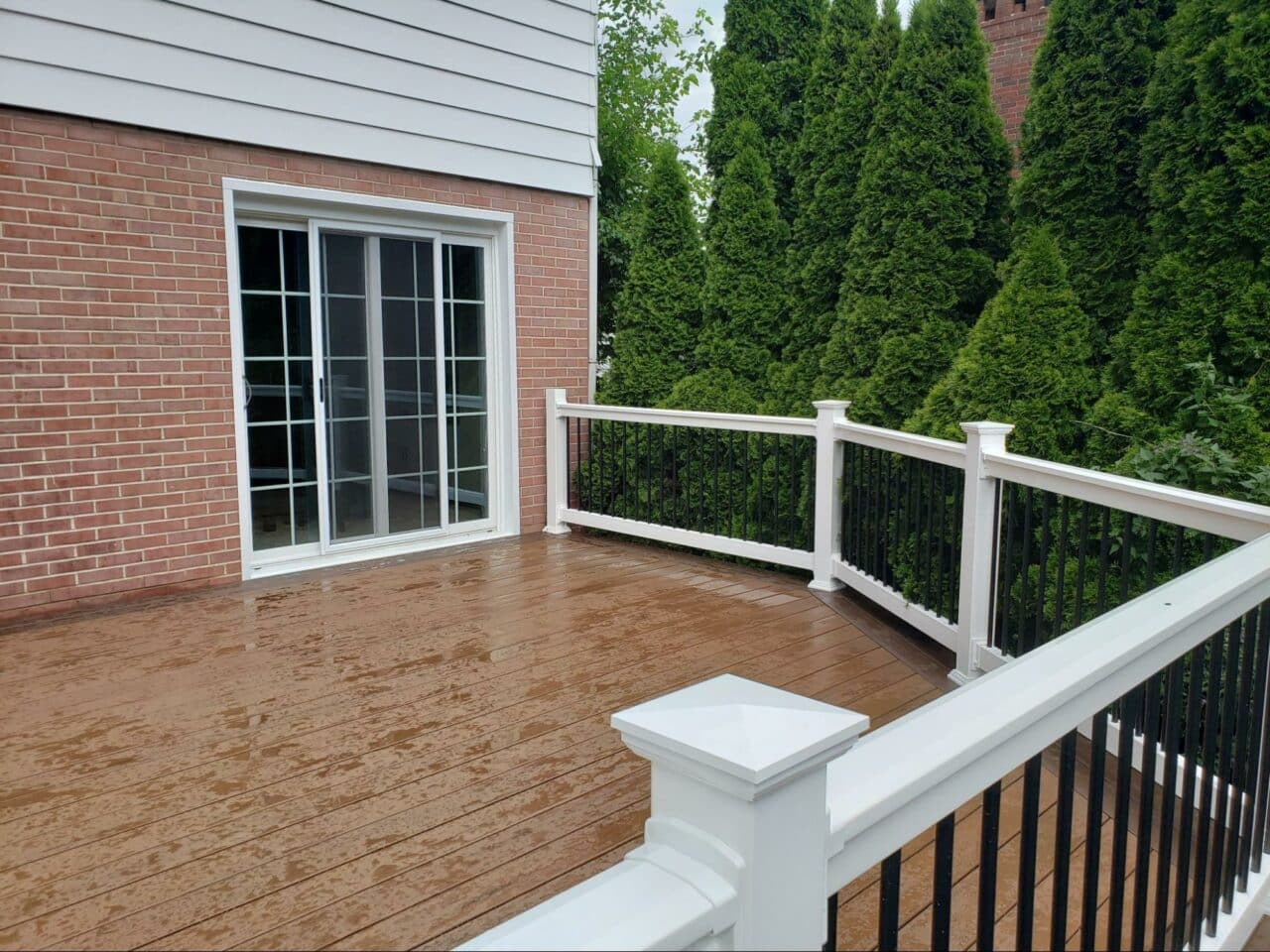 Photo of a custom deck with black and white deck railing.