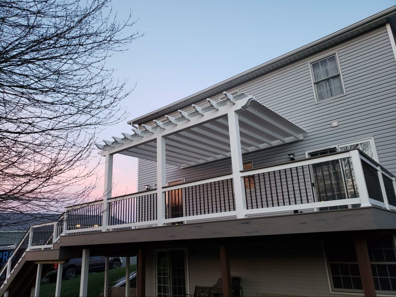 Photo of elevated deck with a white pergola structure