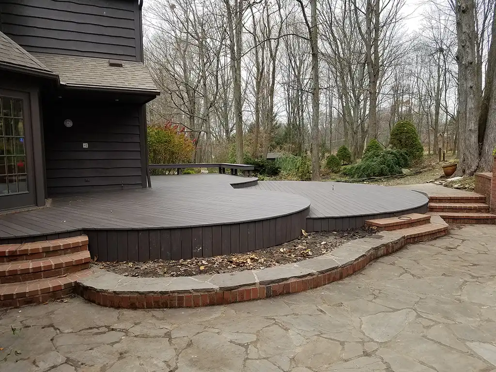 Photo of a home with a curved, multi-level deck.